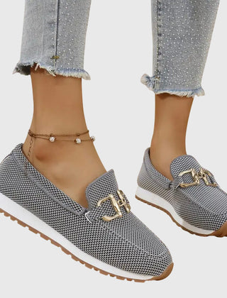 Gray slip-on loafer sneakers with gold buckle detail and white sole trim