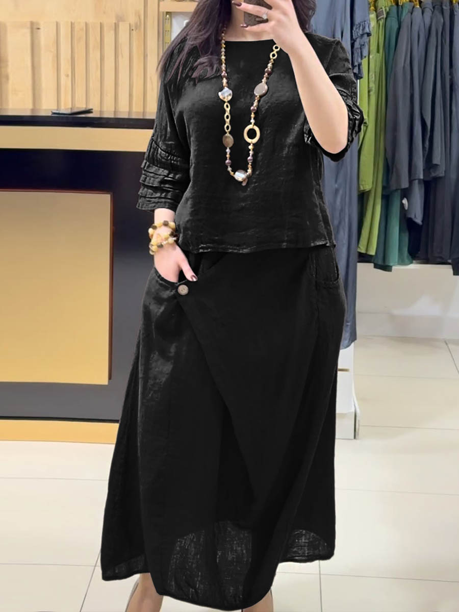 Black two-piece outfit: long-sleeve tunic and gathered midi skirt with pockets