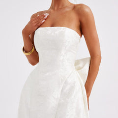White strapless jacquard mini dress with fitted corset-style seams and flared hem