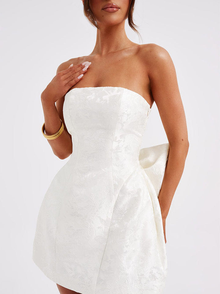 White strapless jacquard mini dress with fitted corset-style seams and flared hem
