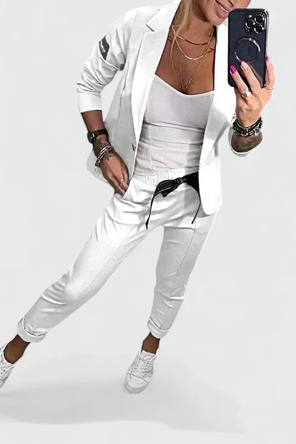 White women's two-piece blazer and jogger set with drawstring waist and sneakers