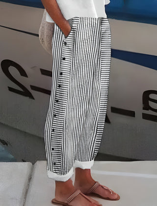 Black-and-white striped trousers with button-front detail, wide leg