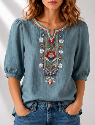 Denim blue embroidered floral blouse with puff sleeves and colorful V-neck detail