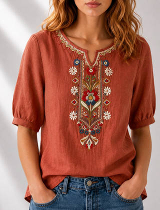 Burnt orange embroidered floral blouse with puff sleeves and V-neck neckline trim