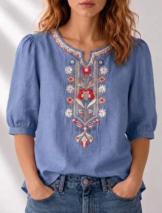 Floral embroidered blue blouse with puff sleeves and V-neck yoke detail