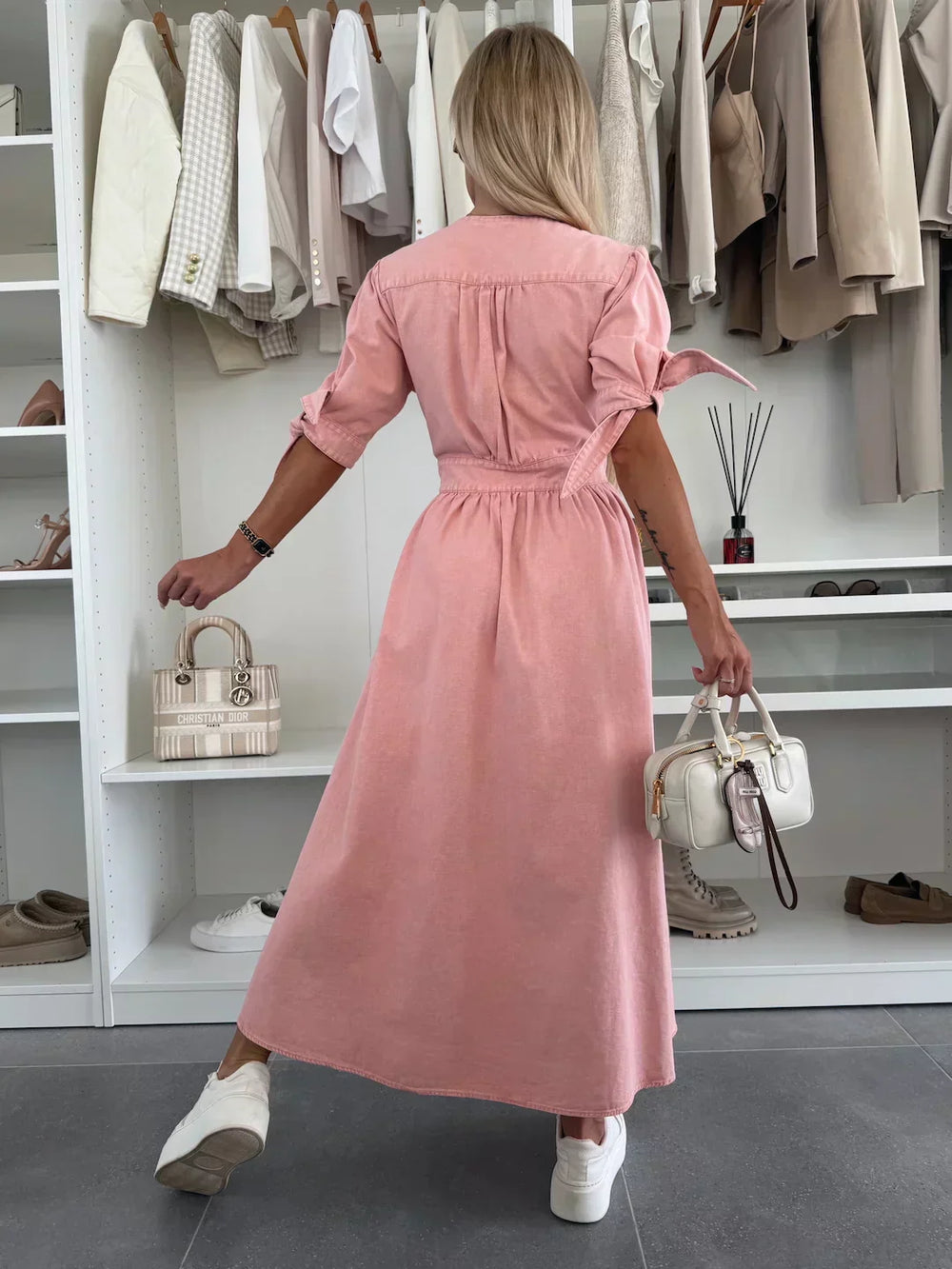 Back view of pink denim midi dress with gathered waist and button-front, short sleeves