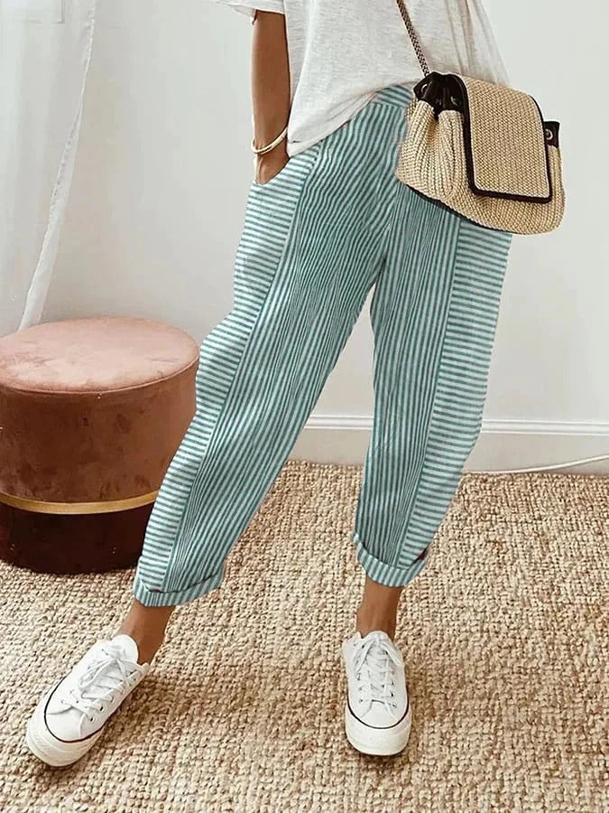 Green striped trousers with wide legs and cuffed ankle hems
