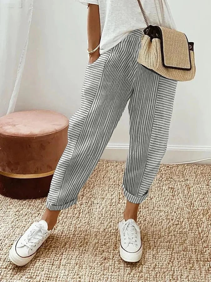 Grey striped trousers with wide legs and cuffed ankle hems