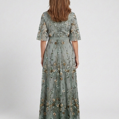 Sage green floral V-neck maxi dress, back view with gathered tiers