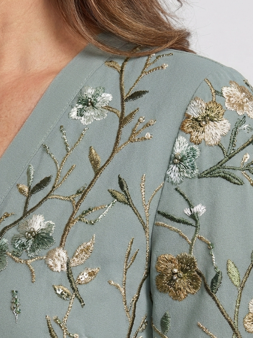 Sage green floral embroidery on the maxi dress bodice and shoulder