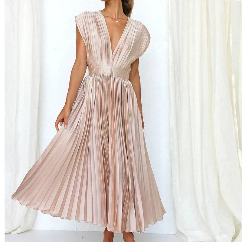 Blush pink pleated midi dress with V-neck, short cap sleeves, and gathered waist