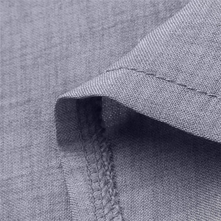 Woven breathable shirt fabric close-up with stitched seam and textured edge
