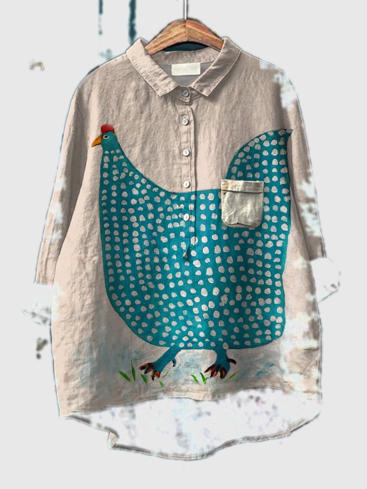Light gray button-up shirt with teal polka-dot chicken graphic and patch pocket