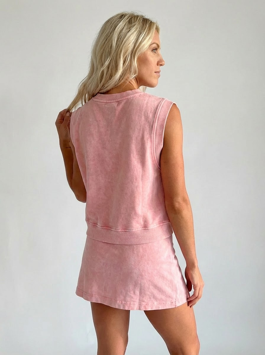 Light pink sleeveless crewneck top and matching short set, back view with side slit