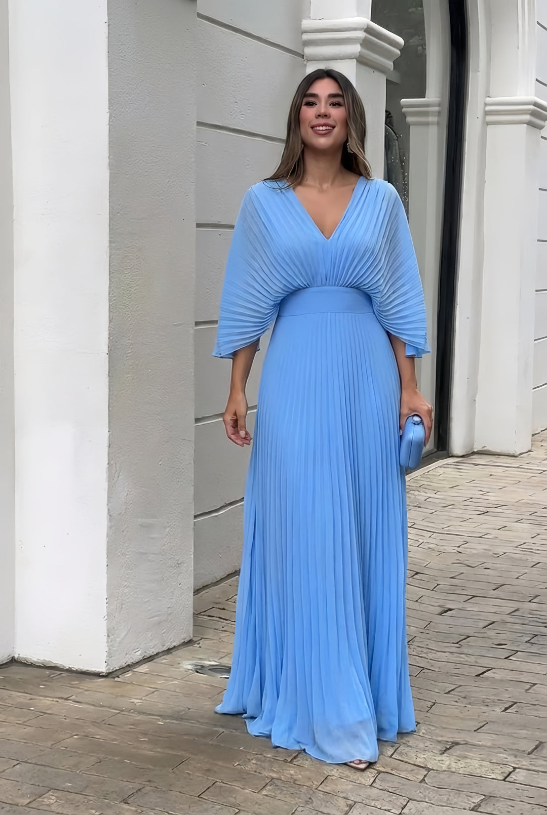 Light blue pleated V-neck maxi dress with gathered waist and flowing skirt