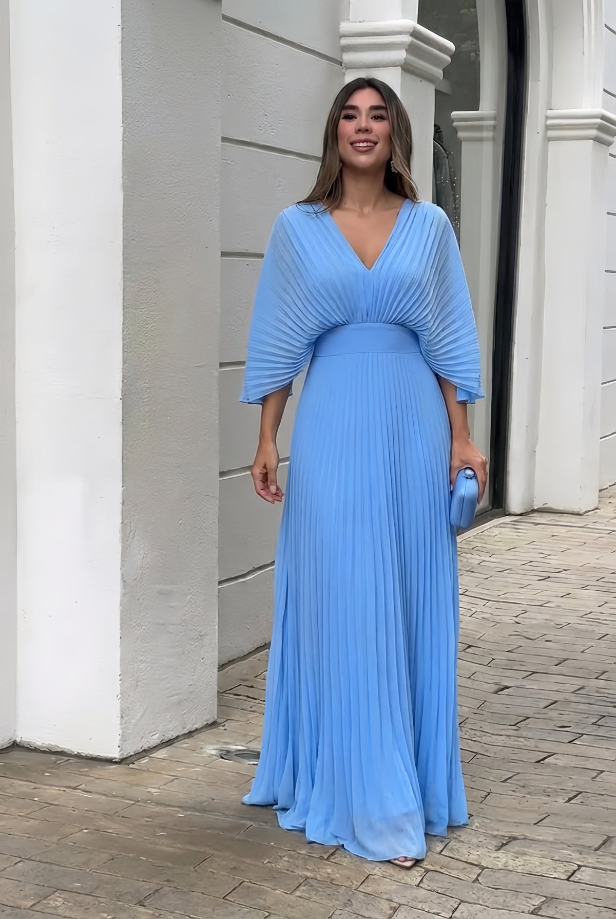Light blue pleated V-neck maxi dress with gathered waist and flowing skirt