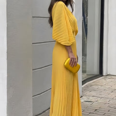 Yellow pleated V-neck maxi dress with three-quarter sleeves, side view