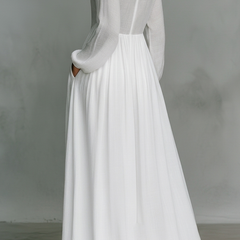White long-sleeve maxi dress with gathered waist and pleated full skirt (back view)