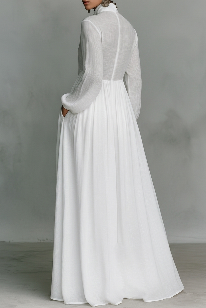 White long-sleeve maxi dress with gathered waist and pleated full skirt (back view)