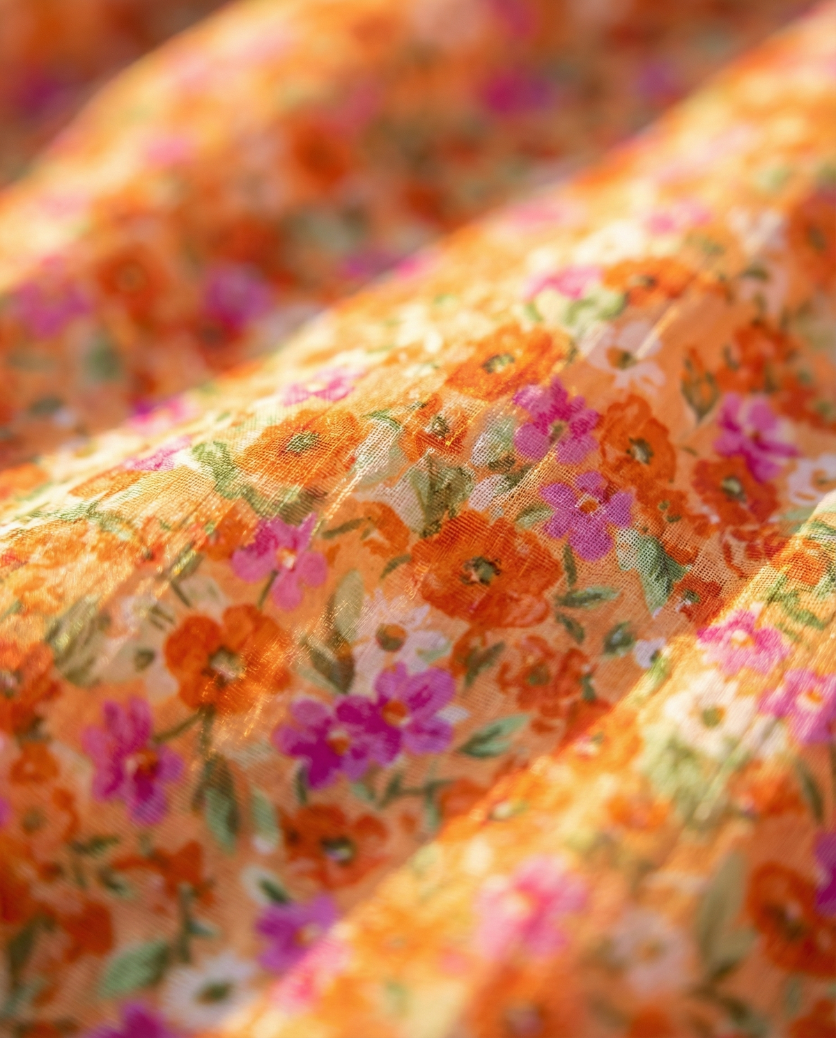 Orange floral fabric texture with small multicolor flower print