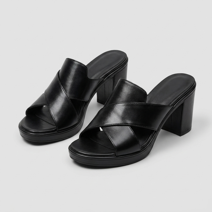 Black platform heeled slide sandals with wide crisscross upper and block heel