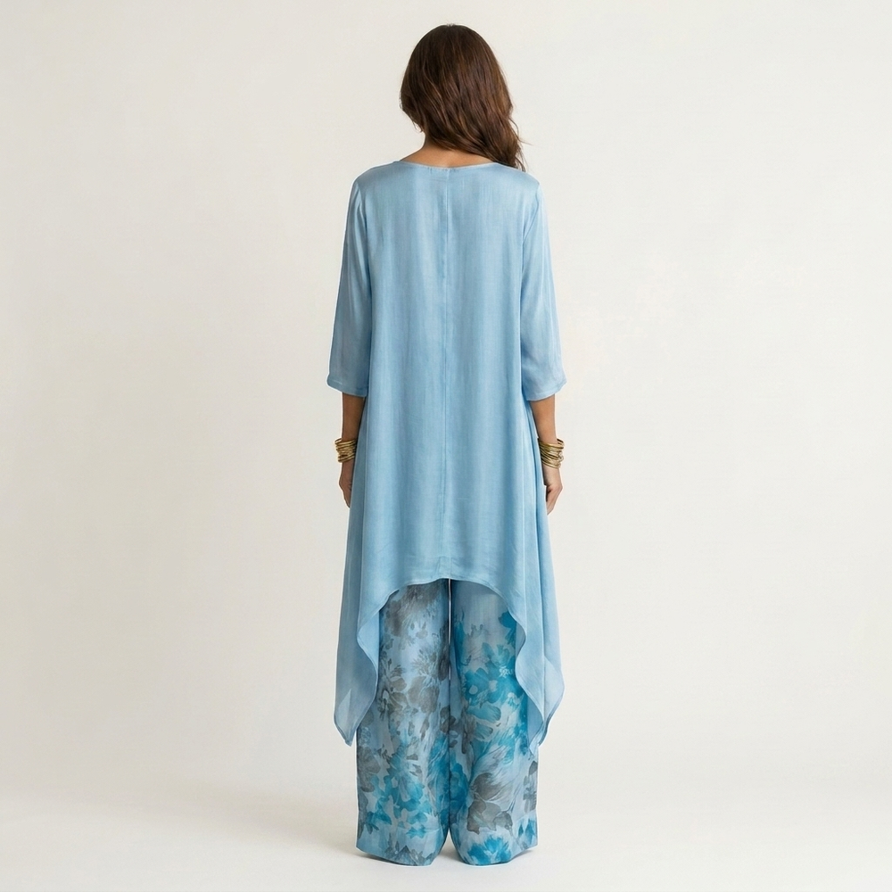Sky-blue draped tunic with 3/4 sleeves and matching floral wide-leg pants, back view