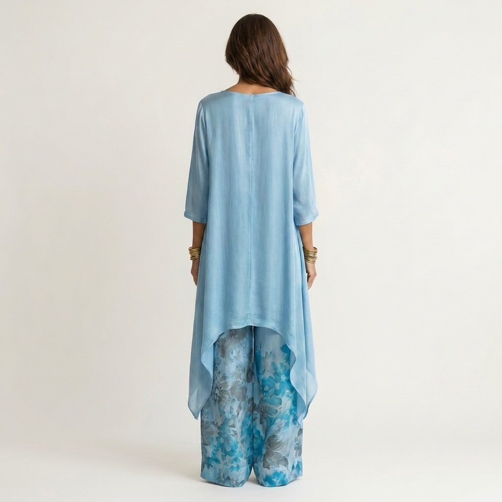 Sky-blue draped tunic with 3/4 sleeves and matching floral wide-leg pants, back view