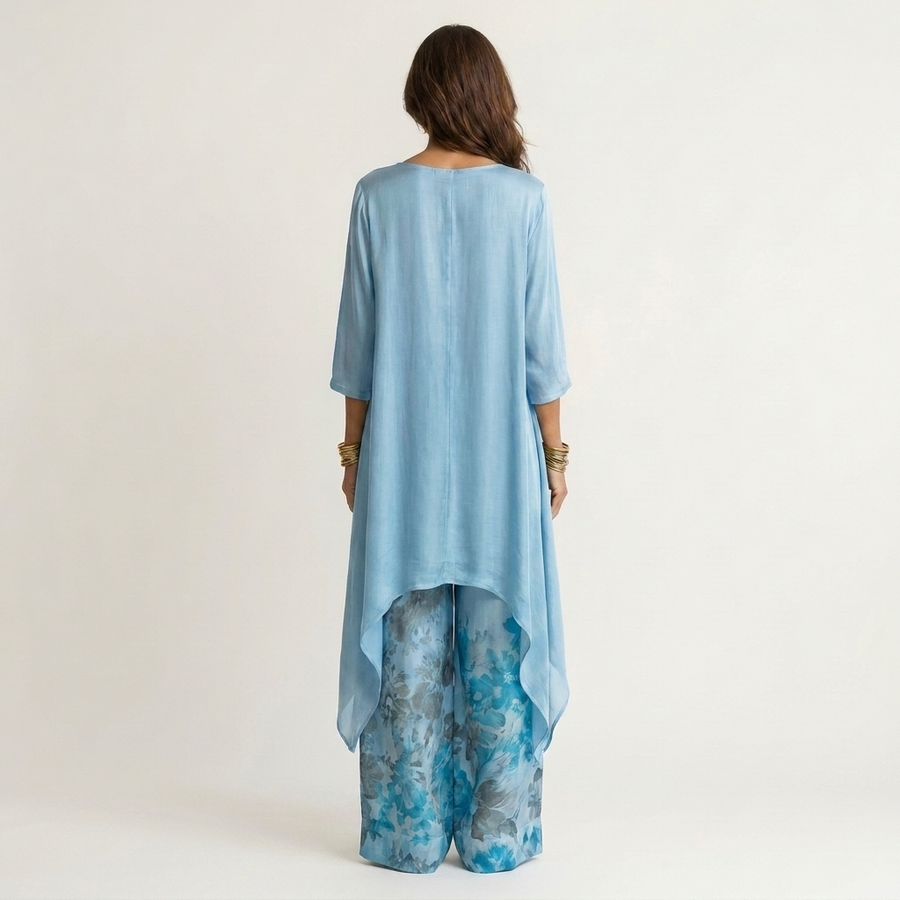 Sky-blue draped tunic with 3/4 sleeves and matching floral wide-leg pants, back view