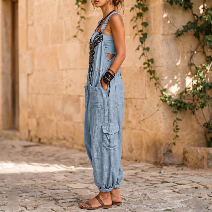 Light blue sleeveless overalls jumpsuit with chest embroidery and side pockets
