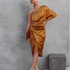 One-shoulder satin silk party dress in gold with draped sleeve detail and wrap skirt