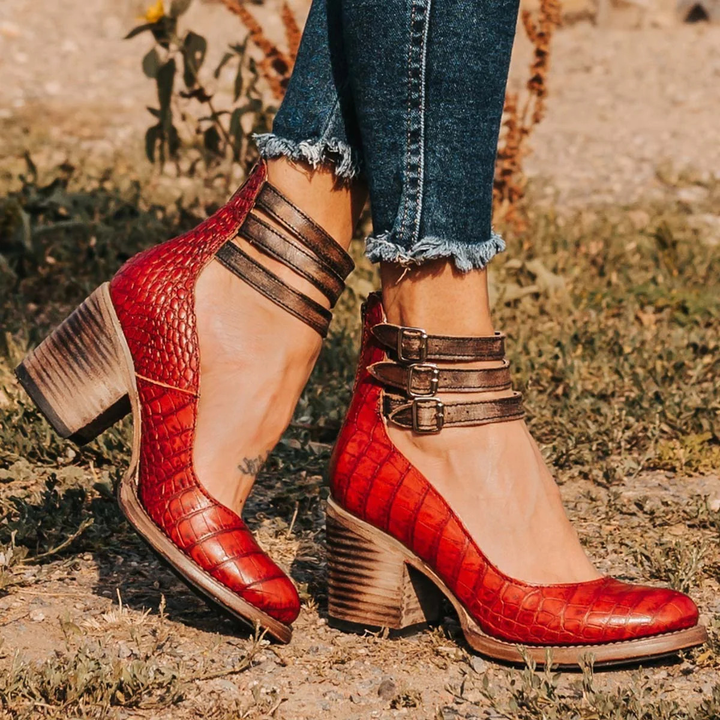 Red embossed ankle strap heeled sandals with buckle closure and block heel