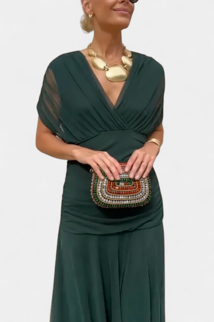Long dark green V-neck dress with draped cap sleeves and gathered waist