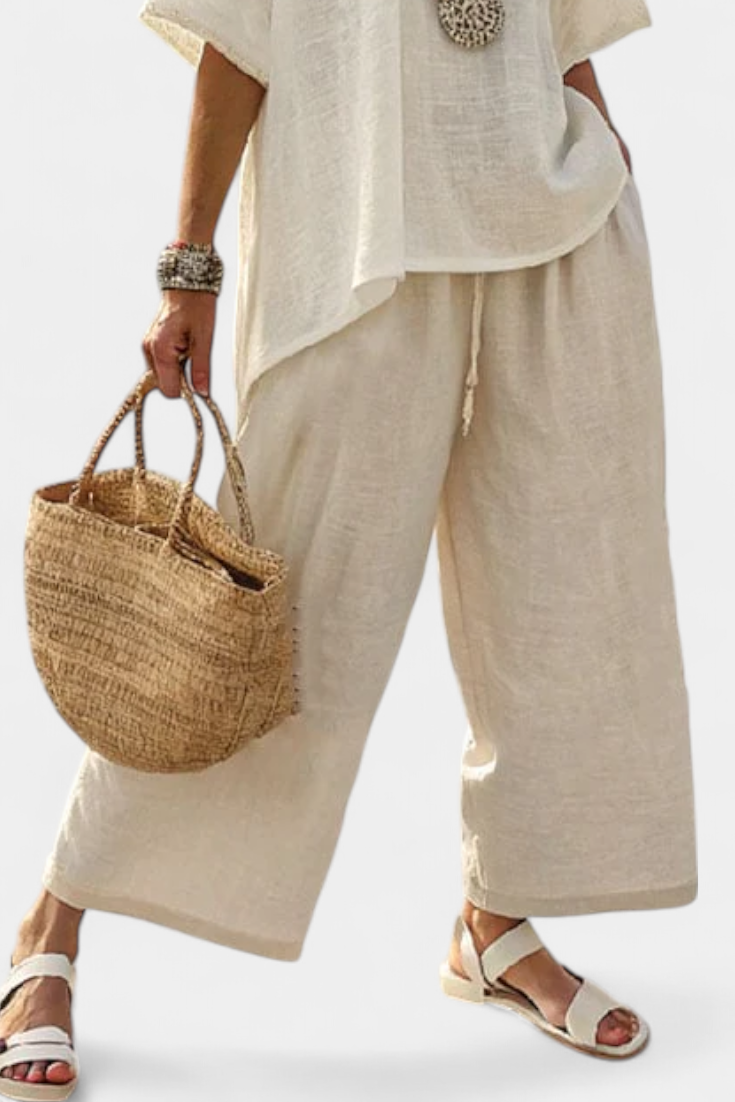Light cream wide-leg pants with matching raw blouse, loose drape, cropped view