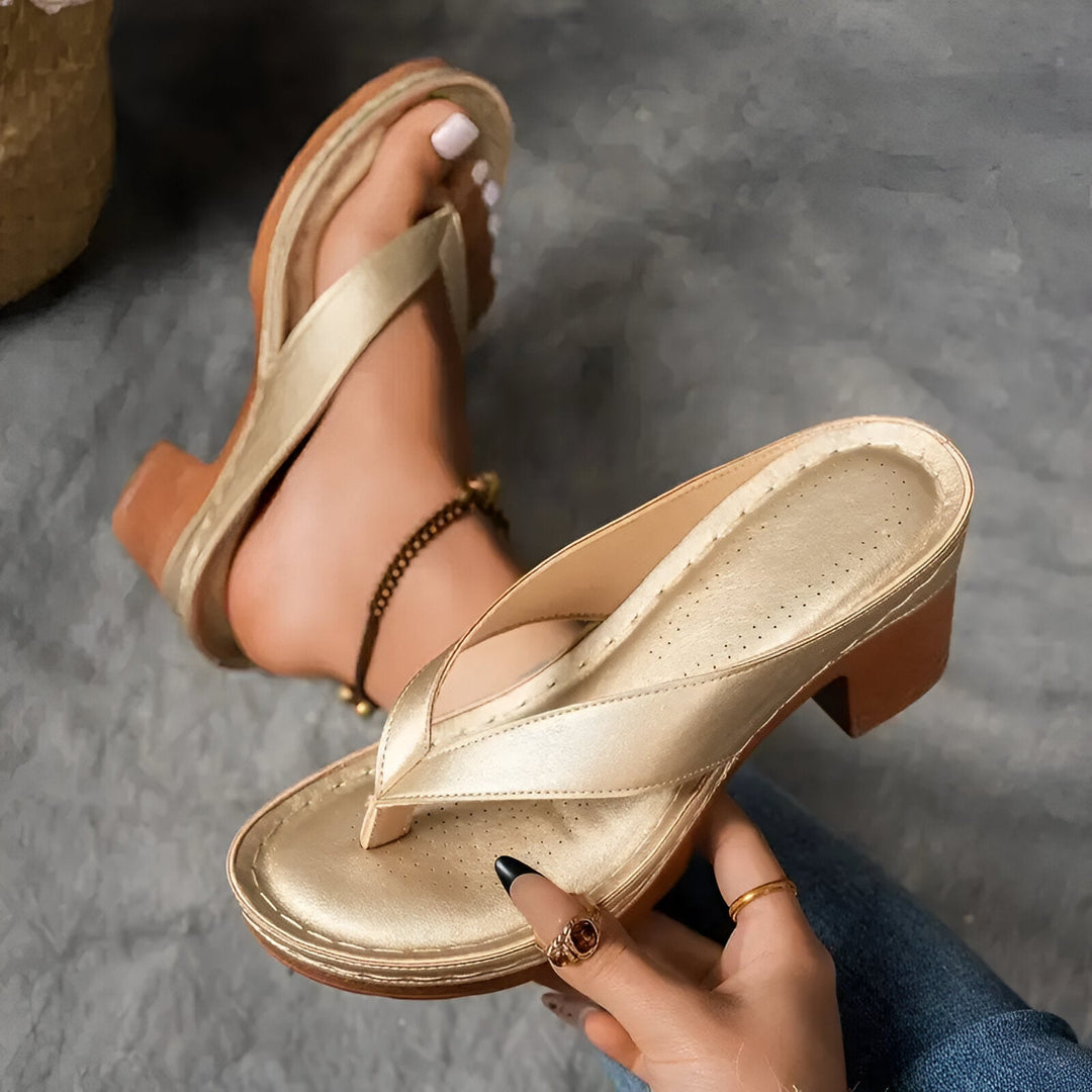 Women’s high-heeled mule sandals in metallic gold with crisscross strap and chunky heel