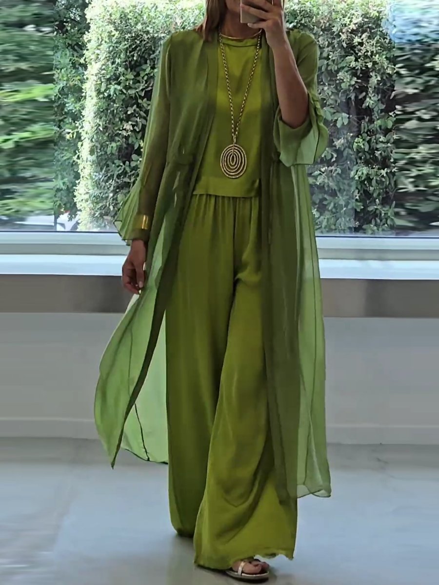 Olive green set with tunic top and wide-leg trousers, wearing an open long cardigan