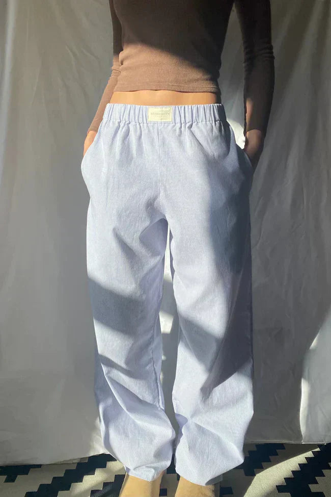 Light blue lounge trousers with elastic waistband and relaxed wide straight legs
