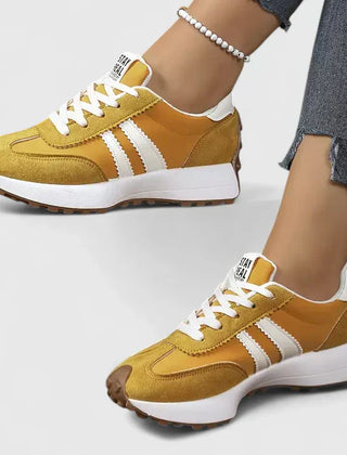 Yellow lace-up orthopedic sneakers with white stripe accents and cushioned sole