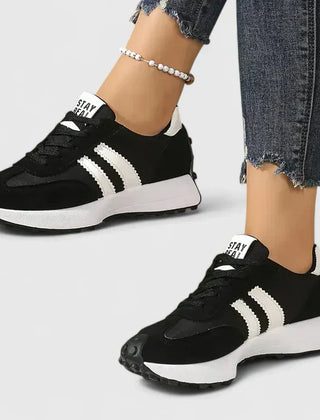 Black lace-up orthopedic sneakers with white stripe accents and cushioned sole