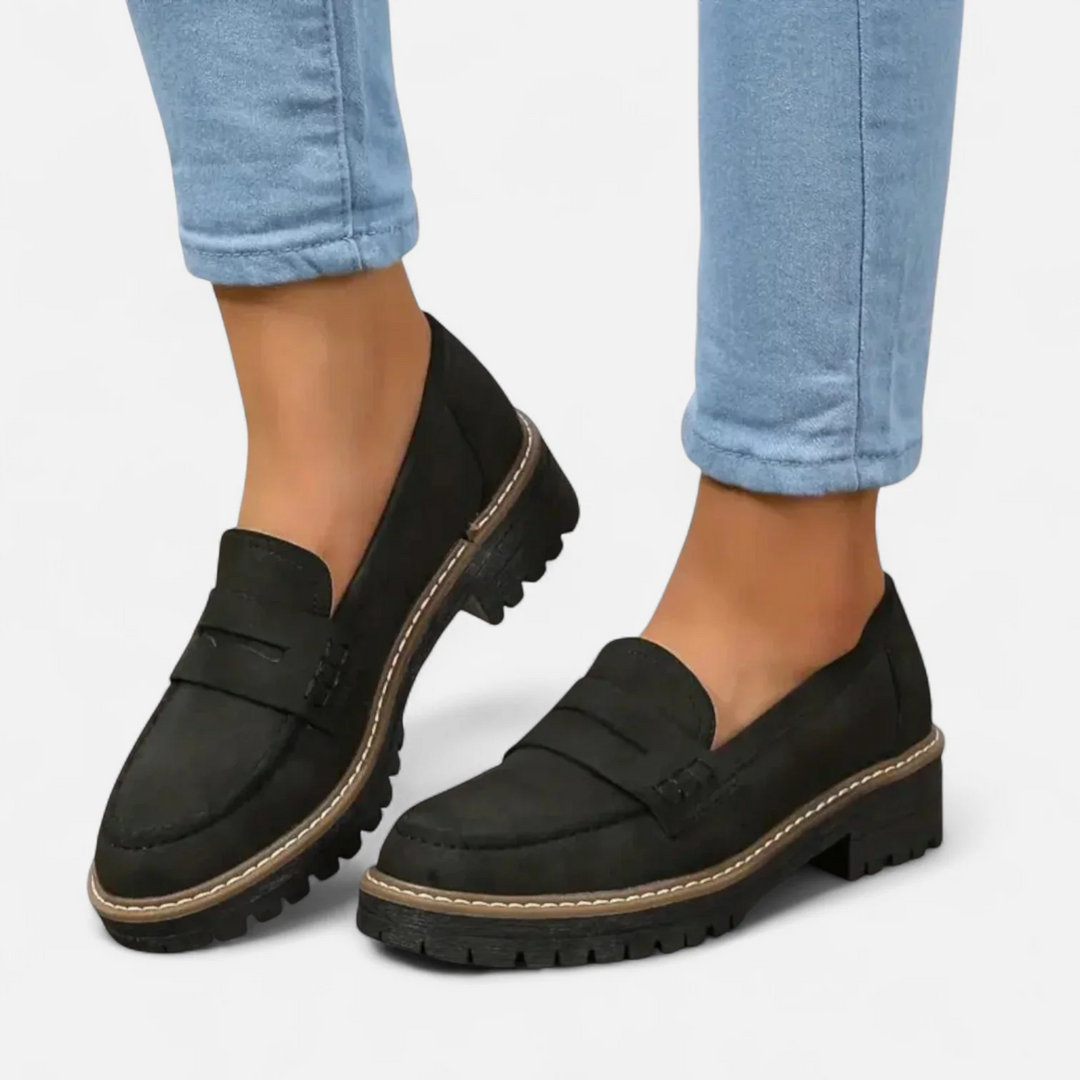 Kaye™ loafers in black with buckle strap, slip-on fit, chunky lug sole and contrast trim