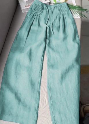 Turquoise wide-leg trousers with elastic waistband, drawstring, and front button