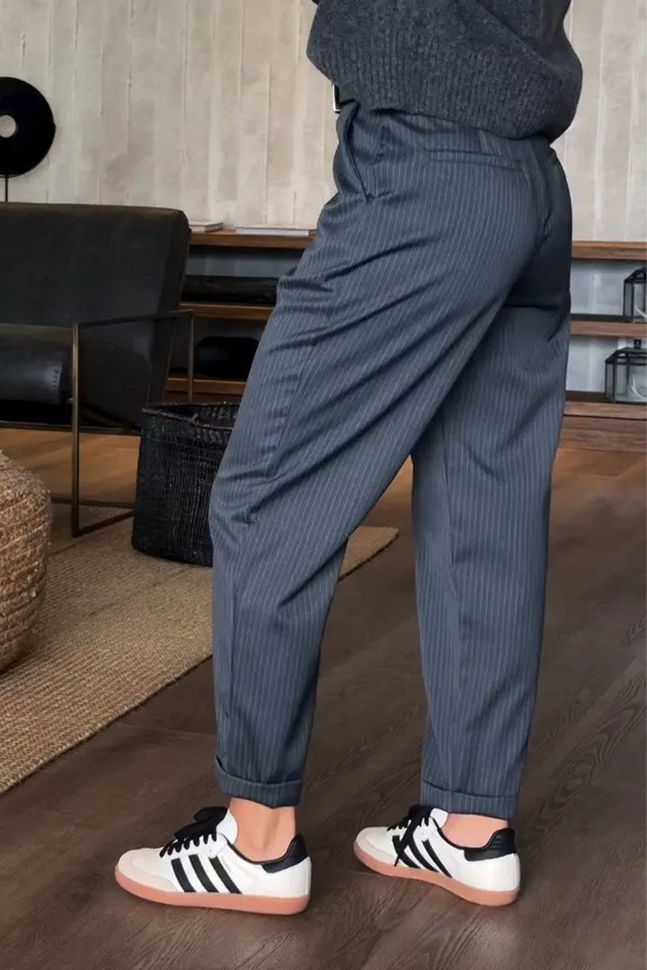 Sleek tailored pants in dark blue pinstripe, front slant pockets, belt loops, cuffed hem