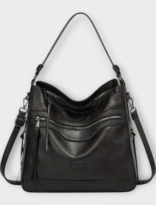Black retro shoulder bag with front zip pockets and tassel detail