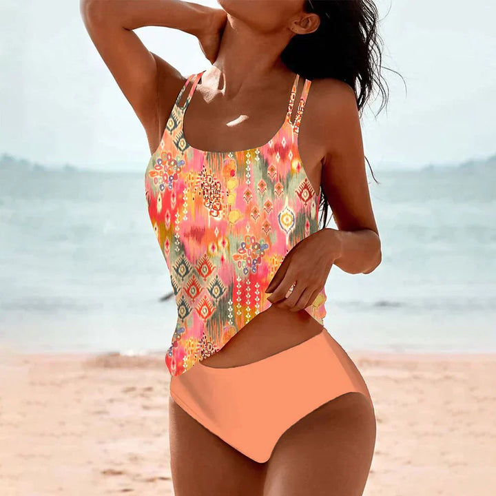 Pink and orange patterned one-piece swim set with scoop neck and high-cut bottoms