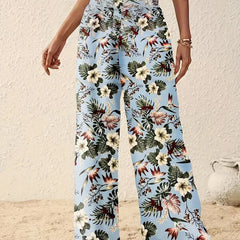 Light blue floral wide-leg trousers with multicolor foliage and flower print