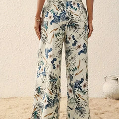 Cream floral wide-leg trousers with blue-green garden leaves and blooms