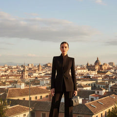 Black tailored blazer and wide-leg palazzo pants set, sleek lapelless neckline.