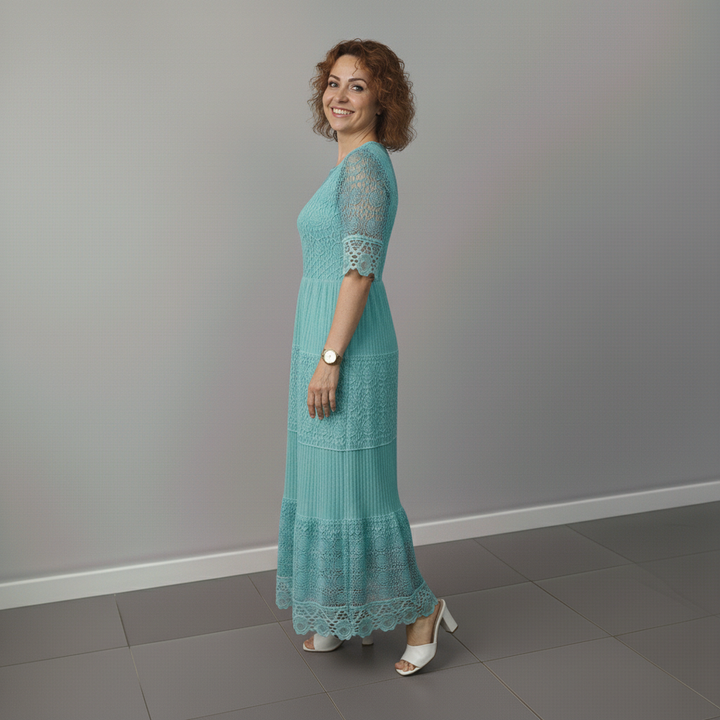 Teal lace midi dress from side view with short lace sleeves and tiered hem