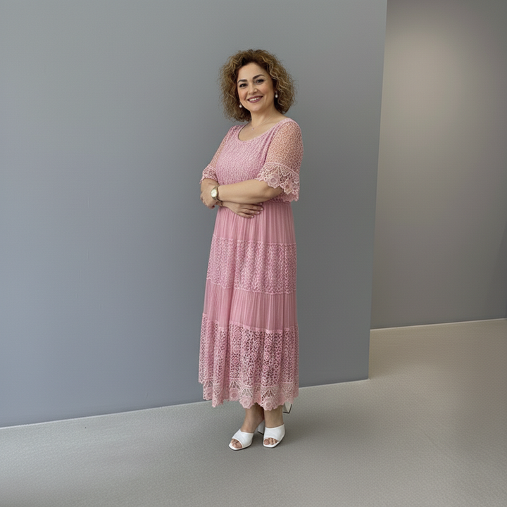 Dusty pink lace midi dress with lace sleeves and patchwork-style tiered skirt