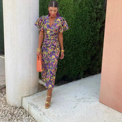 Women’s purple-blue printed midi dress with V-neck and puff sleeves, fitted waist.