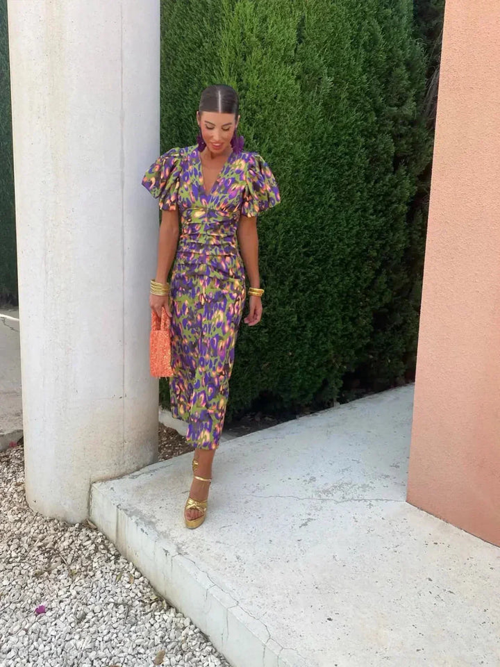 Women’s purple-blue printed midi dress with V-neck and puff sleeves, fitted waist.